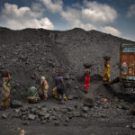 
              Indian laborers load coal into a truck in Dhanbad, an eastern Indian city in Jharkhand state, Friday, Sept. 24, 2021. A 2021 Indian government study found that Jharkhand state -- among the poorest in India and the state with the nation’s largest coal reserves -- is also the most vulnerable Indian state to climate change. Efforts to fight climate change are being held back in part because coal, the biggest single source of climate-changing gases, provides cheap electricity and supports millions of jobs. It's one of the dilemmas facing world leaders gathered in Glasgow, Scotland this week in an attempt to stave off the worst effects of climate change. (AP Photo/Altaf Qadri)
            