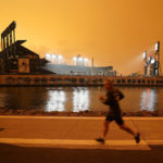 
              FILE - In this Wednesday, Sept. 9, 2020 file photo, a jogger runs along McCovey Cove outside Oracle Park in San Francisco, under darkened skies from wildfire smoke.Health problems tied to climate change are all getting worse, according to two reports published in the medical journal Lancet on Wednesday, Oct. 20, 2021. An unprecedented Pacific Northwest and Canadian heat wave hit this summer, which a previous study showed couldn't have happened without human-caused climate change. (AP Photo/Tony Avelar)
            