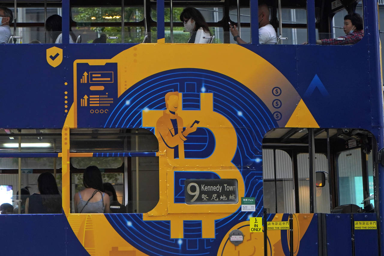 FILE - This May 12, 2021, file photo shows an advertisement for the cryptocurrency Bitcoin displaye...