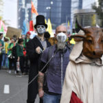 
              Protestors wear costumes as they participate in a climate march in Brussels, Sunday, Oct. 10, 2021. Some 80 organizations are joining in a climate march through Brussels to demand change and push politicians to effective action in Glasgow later this month.(AP Photo/Geert Vanden Wijngaert)
            