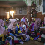 
              Female members of the Sufi Karkariya order chant hymns during a religious celebration of the prophet Muhammed's birthday, in Aroui, near Nador, eastern Morocco, Monday, Oct. 18, 2021. It was the first such gathering since the pandemic. The order, the Karkariya, follows a mystical form of Islam recognizable by its unique dress code: A modest yet colorful patchwork robe. (AP Photo/Mosa'ab Elshamy)
            