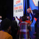 
              President Joe Biden greets people during a break as he participates in a CNN town hall at the Baltimore Center Stage Pearlstone Theater, Thursday, Oct. 21, 2021, in Baltimore. (AP Photo/Evan Vucci)
            