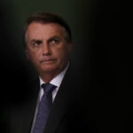 
              FILE - In this Oct. 25, 2021, file photo, President Jair Bolsonaro attends the launching ceremony of the National Green Growth Program at the Planalto presidential palace in Brasilia, Brazil. A Brazilian Senate committee will vote Tuesday, Oct. 26, on a report recommending Bolsonaro face a series of criminal indictments for actions that allegedly added to the world's second-highest COVID-19 death toll. (AP Photo/Eraldo Peres, File)
            