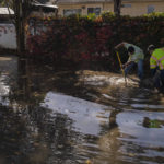 
              Members of Hollister's Department of Public Works clear flood waters on Hillcrest Road in Hollister, Calif., Monday, Oct. 25, 2021. (AP Photo/Nic Coury)
            
