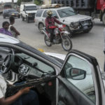 
              A police officer patrols the street of Croix-des-Bouquets, near Port-au-Prince, Haiti, Tuesday, Oct. 19, 2021.  A general strike continues in Haiti demanding that authorities address the nation’s lack of security, four days after 17 members of a U.S.-based missionary group were abducted by a gang. (AP Photo/Matias Delacroix)
            