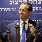 
              Israeli President Isaac Herzog lights candles during the Jewish holiday of Hanukkah in Hebron's holiest site, known to Jews as the Tomb of the Patriarchs and to Muslims as the Ibrahimi Mosque in the Israeli controlled part of the West Bank city of Hebron, Sunday, Nov. 28, 2021, Sunday, Nov. 28, 2021. (AP Photo/Oren Ziv)
            