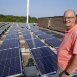 
              Operations director Ken Reineccius of Pax Christi Catholic Community poses Aug. 19, 2021 beside rows of solar panels atop the church roof in Eden Prairie, Minn. The suburban church near the Twin Cities is among many community solar providers popping up around the U.S. as surging demand for renewable energy inspires new approaches. (AP Photo/Jim Mone)
            