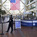 
              A security guard stands next to the cordoned off atrium, Tuesday, Nov. 30, 2021 at the Hennepin County Government Center in Minneapolis where jury selection begins for former suburban Minneapolis police officer Kim Potter, who says she meant to grab her Taser instead of her handgun when she shot and killed motorist Daunte Wright. (AP Photo/Jim Mone)
            