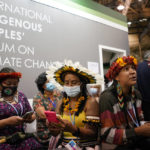
              Members of the International Indigenous People's Forum on Climate Change look at their phones at the COP26 U.N. Climate Summit, in Glasgow, Scotland, Wednesday, Nov. 3, 2021. The U.N. climate summit in Glasgow gathers leaders from around the world, in Scotland's biggest city, to lay out their vision for addressing the common challenge of global warming. (AP Photo/Alberto Pezzali)
            