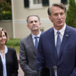 
              Virginia Gov.-elect Glenn Youngkin, right, addresses the media as Gov. Ralph Northam, center, and his wife, Pam, listen after a transition luncheon in front of the Mansion at the Capitol in Richmond, Va., Thursday, Nov. 4, 2021. (AP Photo/Steve Helber)
            