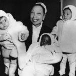 
              FILE- Actress Josephine Baker in her apartment at the Hotel Forresta near Stockholm, Sweden on Dec. 7, 1957, with three of her adopted children, Marianne, left, Koffi, center, and Brahim. France is inducting Josephine Baker – Missouri-born cabaret dancer, French Resistance fighter and civil rights leader – into its Pantheon, the first Black woman honored in the final resting place of France's most revered luminaries. (AP Photo, File)
            