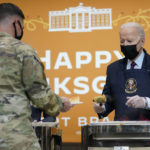 
              President Joe Biden serves dinner during a visit to soldiers at Fort Bragg to mark the upcoming Thanksgiving holiday, Monday, Nov. 22, 2021, in Fort Bragg, N.C. (AP Photo/Evan Vucci)
            