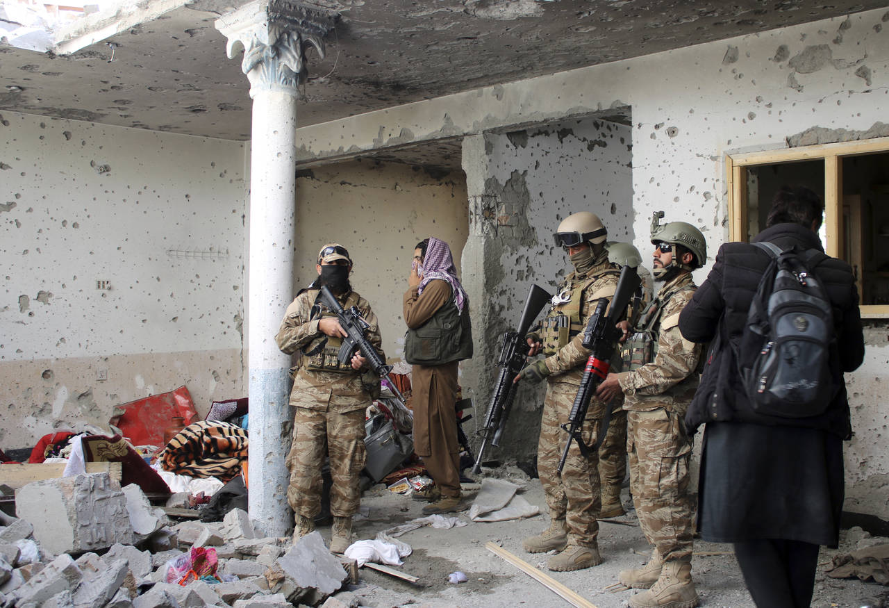 Taliban fighters inspect a house after an 8-hour gunbattle erupted between Taliban and Islamic Stat...
