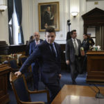 
              Kyle Rittenhouse, center, pulls out his chair for a meeting Judge Bruce Schroeder called during his trial at the Kenosha County Courthouse in Kenosha, Wis., on Thursday, Nov. 18, 2021. (Sean Krajacic/The Kenosha News via AP, Pool)
            