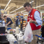 
              Virginia Governor-Elect Glenn Youngking bags groceries at the Abingdon Food City on Tuesday, Nov. 23, 2021 in Abingdon, Va.. Youngkin took part in the United Way of Southwest Virginia 15th annual Celebrity Bagging Event in support of their annual fundraising campaign. Youngkin bagged groceries for about an hour during the stop in Abingdon. (David Crigger/Bristol Herald Courier via AP)
            