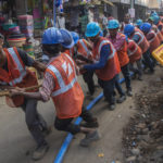 
              FILE - Workers prepare work to lay an underground electricity cable in Mumbai, India Wednesday, Nov. 24, 2021. India’s economy grew by 8.4% in the July-September quarter from the same period a year earlier, the government announced Tuesday, signaling hopes of a growing economic recovery after it suffered historic contractions sparked by the COVID-19 pandemic. (AP Photo/Rafiq Maqbool, File)
            