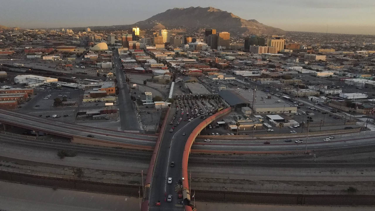 Cars line up at the Paso del Norte international bridge in Ciudad Juarez, Mexico, below, on the bor...
