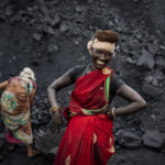 
              An Indian laborer smiles as she takes a break from loading coal into a truck in Dhanbad, an eastern Indian city in Jharkhand state, Friday, Sept. 24, 2021. A 2021 Indian government study found that Jharkhand state -- among the poorest in India and the state with the nation’s largest coal reserves -- is also the most vulnerable Indian state to climate change. Efforts to fight climate change are being held back in part because coal, the biggest single source of climate-changing gases, provides cheap electricity and supports millions of jobs. It's one of the dilemmas facing world leaders gathered in Glasgow, Scotland this week in an attempt to stave off the worst effects of climate change. (AP Photo/Altaf Qadri)
            
