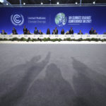 
              A view of the shadows of photographers as Britain's Chancellor Rishi Sunak, centre right, and Prime Minister Boris Johnson's Finance Adviser for COP26, Mark Carney, centre left, pose for a photo with world finance ministers, during the COP26 summit, at the Scottish Event Campus (SEC) in Glasgow, Scotland, Wednesday, Nov. 3, 2021. (Christopher Furlong/Pool Photo via AP)
            