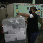 
              An election worker casts her ballot during general elections in Tegucigalpa, Honduras, Sunday, Nov. 28, 2021. The National Electoral Council called on political parties to refrain from declaring their candidates victorious or providing partial vote totals while voting was ongoing. (AP Photo/Moises Castillo)
            