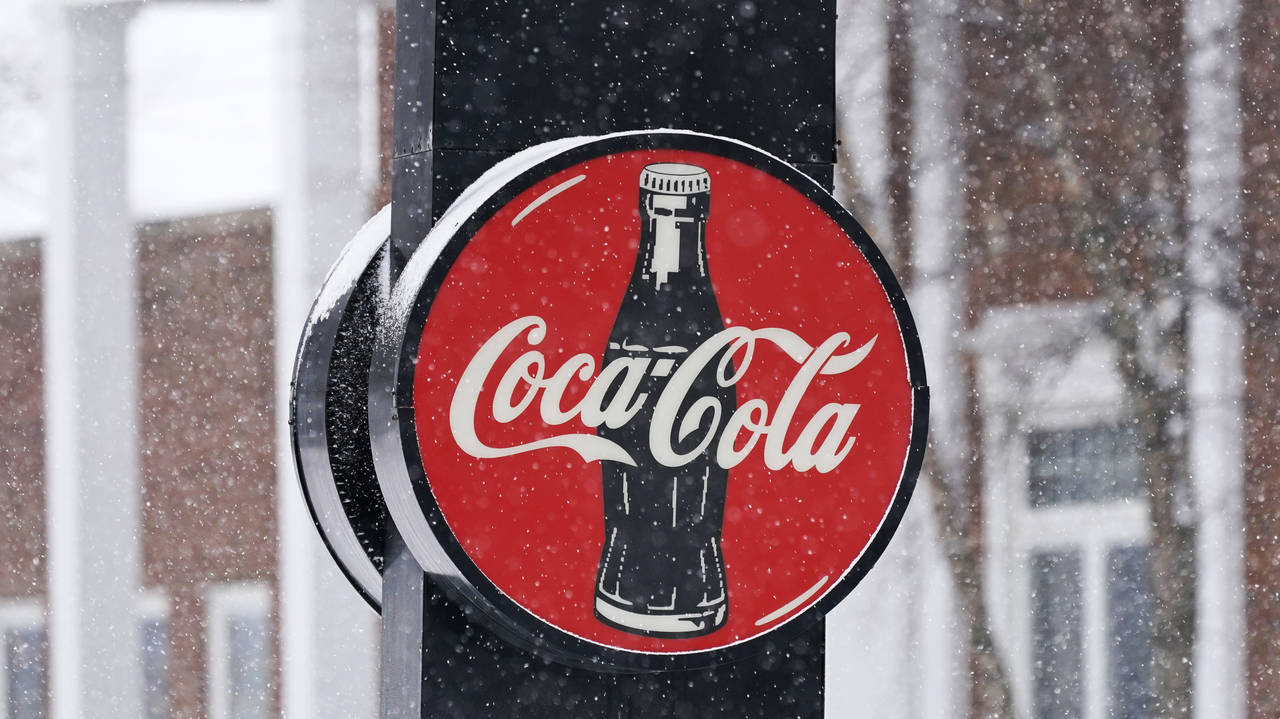 FILE - A Coca-Cola sign hangs outside a Coca-Cola distributor, Tuesday, Feb. 9, 2021, in Bedford, O...