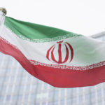 
              FILE - The flag of Iran waves in front of the the International Center building with the headquarters of the International Atomic Energy Agency, IAEA, in Vienna, AustriaI, May 24, 2021. On Monday, Nov. 29, 2021, negotiators are gathering in Vienna to resume efforts to revive Iran's 2015 nuclear deal with world powers, with hopes of quick progress muted after the arrival of a hard-line new government in Tehran led to a more than five-month hiatus. (AP Photo/Florian Schroetter, FILE)
            