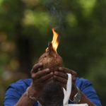 
              A Indian man prays with lit coconut as an offering outside a temple during the Hindu festival of lights, Diwali, in Kuala Lumpur, Malaysia, Thursday, Nov. 4, 2021.  Millions of people across Asia are celebrating the Hindu festival of Diwali, which symbolizes new beginnings and the triumph of good over evil and light over darkness. Millions of people across Asia are celebrating the Hindu festival of Diwali, which symbolizes new beginnings and the triumph of good over evil and light over darkness. The festival is celebrated mainly in India but Hindus across the world, particularly in other parts of Asia, also gather with family members and friends to socialize, visit temples and decorate houses with small oil lamps made from clay.  (AP Photo/Vincent Thian)
            