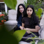 
              Shola Yawari, left, and her teenage daughter Asma Yawari pose for photos at their home in Aurora, Ill., Wednesday, Sept. 22, 2021. Asma Yawari has built a close friendship with her younger cousin in Afghanistan through phone calls and text messages. Since the Taliban takeover, both Asma and her mother worry for their relative's future, amid uncertainty over her access to school and ability to pursue her interests and passions. (AP Photo/Nam Y. Huh)
            