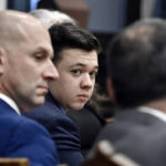 
              Kyle Rittenhouse, center, looks over to his attorneys as the jury is dismissed for the day during his trial at the Kenosha County Courthouse in Kenosha, Wis., on Thursday, Nov. 18, 2021. (Sean Krajacic/The Kenosha News via AP, Pool)
            