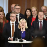 
              Swedish Prime Minister Magdalena Andersson, center, with her new cabinet members behind her, speaks during a press conference, in Stockholm, Tuesday, Nov. 30, 2021. Andersson, the first woman to ever hold that post in Sweden, has presented her one-party, minority government with only few changes compared to the previous one. (Soeren Andersson/TT via AP)
            
