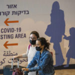
              Travelers wearing protective face masks arrive at Ben Gurion Airport near Tel Aviv, Israel, Sunday, Nov. 28, 2021. Israel on Sunday approved barring entry to foreign nationals and the use of controversial technology for contact tracing as part of its efforts to clamp down on a new coronavirus variant. (AP Photo/Ariel Schalit)
            