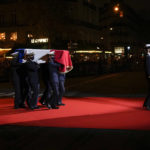 
              The coffin with soils from the U.S., France and Monaco is carried towards the Pantheon monument, rear, in Paris, France, Tuesday, Nov. 30, 2021, where Josephine Baker is to symbolically be inducted, becoming the first Black woman to receive France's highest honor. Her body will stay in Monaco at the request of her family. (AP Photo/Christophe Ena)
            