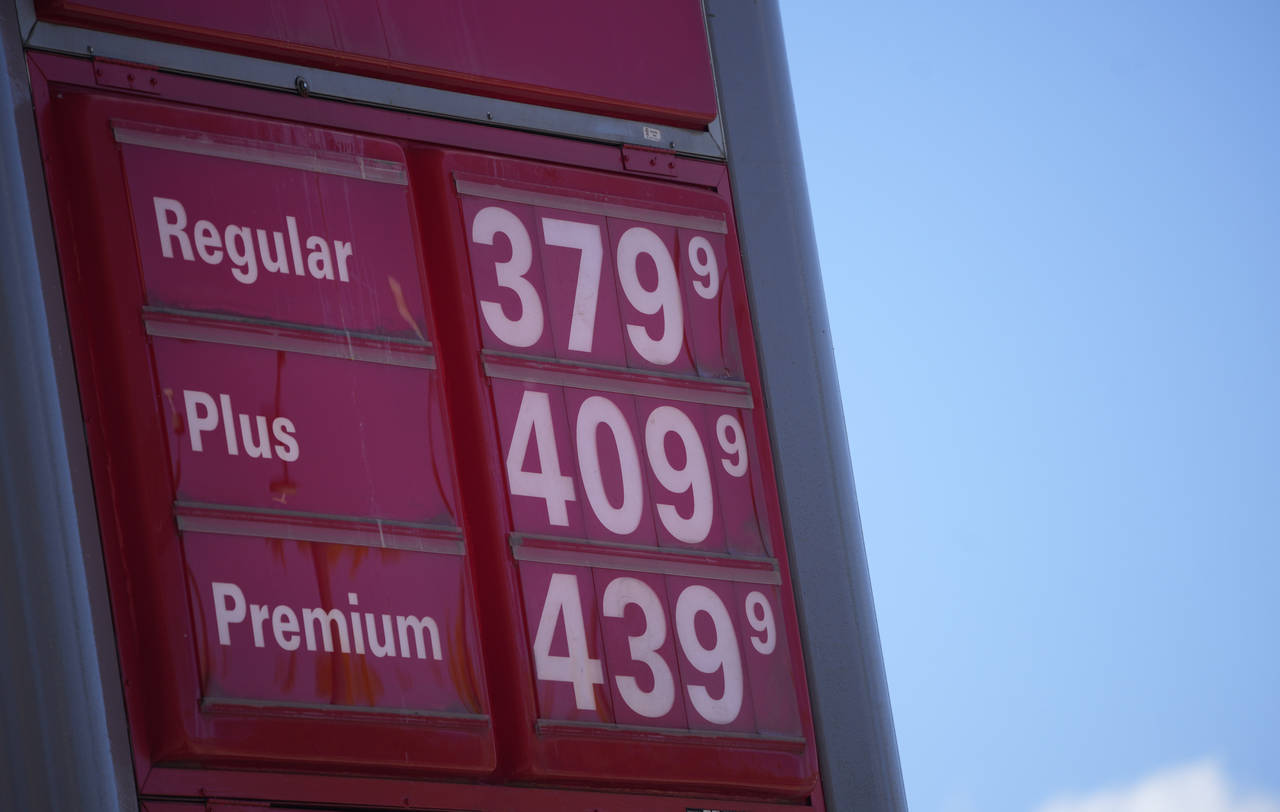 FILE - In this Oct. 24 2021, file photo, gas pump prices are posted on a sign at a Conoco station i...