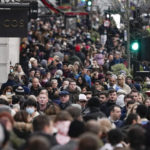 
              People, some wearing face masks, walk in Regent Street, in London, Sunday, Nov. 28, 2021. Britain's Prime Minister Boris Johnson said it was necessary to take "targeted and precautionary measures" after two people tested positive for the new variant in England. He also said mask-wearing in shops and on public transport will be required. (AP Photo/Alberto Pezzali)
            