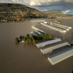 
              Rising flood waters are seen surrounding barns in Abbotsford, British Columbia, Tuesday, Nov. 16, 2021. (Jonathan Hayward/The Canadian Press via AP)
            