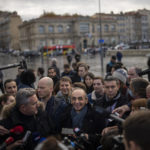 
              FILE - Far-right political talk-show star Eric Zemmour speaks to media outside of the Major Cathedral in Marseille, southern France, Nov. 27, 2021. A far-right former TV pundit with multiple hate-speech convictions is poised to officially enter the race for France's presidency, having already shaken it up with his anti-immigration, anti-Islam invective. (AP Photo/Daniel Cole, File)
            