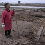 
              Wang Yuetang stands near what used to be his peanut farm before torrential rains submerged the lowland leaving him with no summer harvest near Xubao village in central China's Henan province on Friday, Oct. 22, 2021. The flooding disaster in July is the worst that older farmers can remember in 40 years – but it is also a preview of the kind of extreme conditions the country is likely to face as the planet warms up, and weather patterns farmers depend upon are increasingly destabilized. (AP Photo/Ng Han Guan)
            
