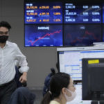 
              A currency trader runs at the foreign exchange dealing room of the KEB Hana Bank headquarters in Seoul, South Korea, Tuesday, Nov. 30, 2021. Asian shares were mixed Tuesday as investors continued to cautiously weigh how much damage the new omicron coronavirus variant may unleash on the global economy. (AP Photo/Ahn Young-joon)
            