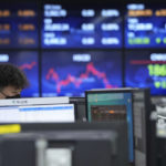 
              A currency trader works at the foreign exchange dealing room of the KEB Hana Bank headquarters in Seoul, South Korea, Tuesday, Nov. 30, 2021. Asian shares were mixed Tuesday as investors continued to cautiously weigh how much damage the new omicron coronavirus variant may unleash on the global economy. (AP Photo/Ahn Young-joon)
            