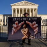 
              Stephen Parlato of Boulder, Colo., holds a sign that reads "Hands Off Roe!!!" outside of the Supreme Court in Washington, Tuesday, Nov. 30, 2021, as activists begin to arrive ahead of arguments on abortion at the court in Washington.(AP Photo/Andrew Harnik)
            