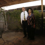 
              Frank and Michelle Meeks stand in their backyard in Arlington, Texas, on Sunday, Oct. 24, 2021, with a fracking site, hidden by "sound walls," looming behind them. The site, called "Rocking Horse," is operated by TEP Barnett, a subsidiary of French energy giant Total Energies and is just a few hundred feet from their home. Beyond concerns about long-term health risks posed by fracking, the Meeks say they've endured frequent drilling noise and vibration in recent months. They and other neighbors also say the drilling has damaged their homes' foundations. (AP Photo/Martha Irvine)
            