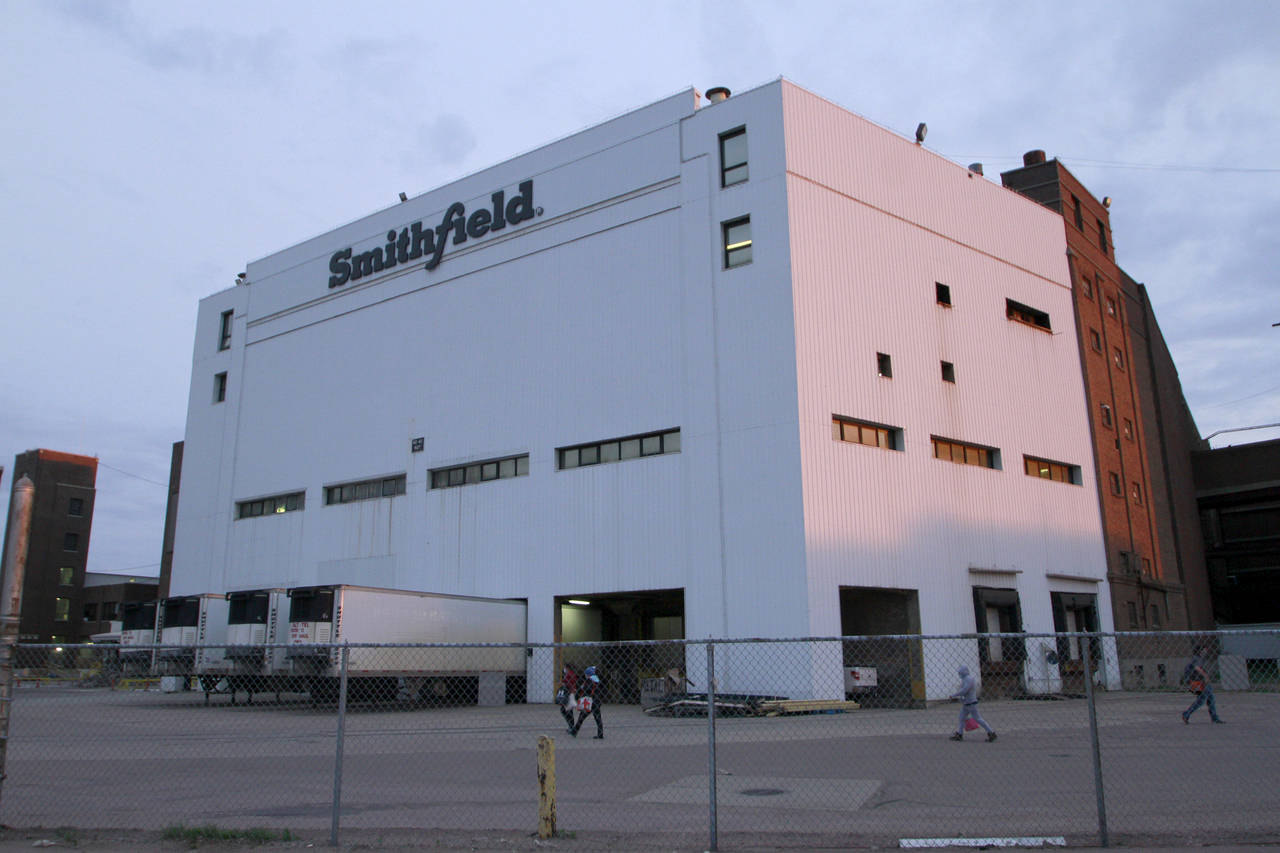 FILE - Employees of two departments at the Smithfield pork processing plant in Sioux Falls, S.D. re...