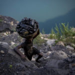 
              A man climbs a steep ridge with a basket of coal scavenged from a mine near Dhanbad, an eastern Indian city in Jharkhand state, Friday, Sept. 24, 2021. A 2021 Indian government study found that Jharkhand state -- among the poorest in India and the state with the nation’s largest coal reserves -- is also the most vulnerable Indian state to climate change. Efforts to fight climate change are being held back in part because coal, the biggest single source of climate-changing gases, provides cheap electricity and supports millions of jobs. It's one of the dilemmas facing world leaders gathered in Glasgow, Scotland this week in an attempt to stave off the worst effects of climate change. (AP Photo/Altaf Qadri)
            