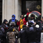 
              Justin Blake, uncle of Jacob Blake, raises his fist outside the Kenosha County Courthouse, Thursday, Nov. 18, 2021 in Kenosha, Wis., during the Kyle Rittenhouse murder trial. Rittenhouse is accused of killing two people and wounding a third during a protest over police brutality in Kenosha, last year. (AP Photo/Paul Sancya)
            