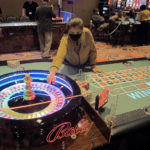 
              This June 23, 2021 photo shows a dealer conducting a game of roulette at Bally's casino in Atlantic City, N.J. Rhode Island-based Bally's Corp. is spending $100 million on renovations to the property, which ranks last among Atlantic City's nine casinos in terms of gambling revenue. (AP Photo/Wayne Parry)
            