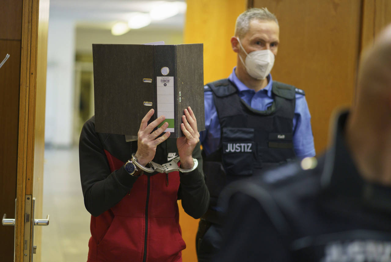 The Iraqi Taha Al-J. is led into the courtroom at Frankfurt's Higher Regional Court before the verd...