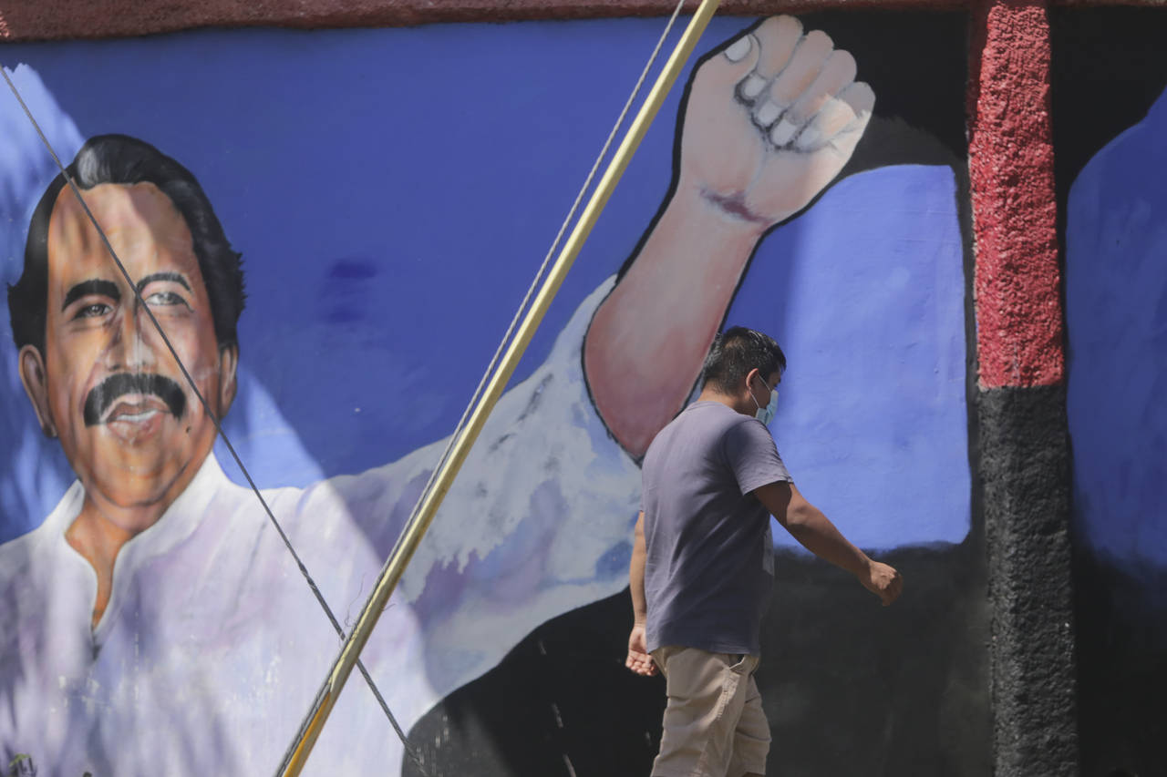 A man walks past a mural of Nicaraguan President Daniel Ortega during general elections in Managua,...
