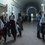 
              Afghan girls exit classrooms at Tajrobawai Girls High School, in Herat, Afghanistan, Thursday, Nov. 25, 2021. While most high school girls in Afghanistan are forbidden to attend class by the country's Taliban rulers, one major exception are those in the western province of Herat. For weeks, girls there have been attending high school classes, thanks to a unique effort by teachers and parents to persuade local Taliban administrators to allow schools to reopen. (AP Photo/Petros Giannakouris)
            