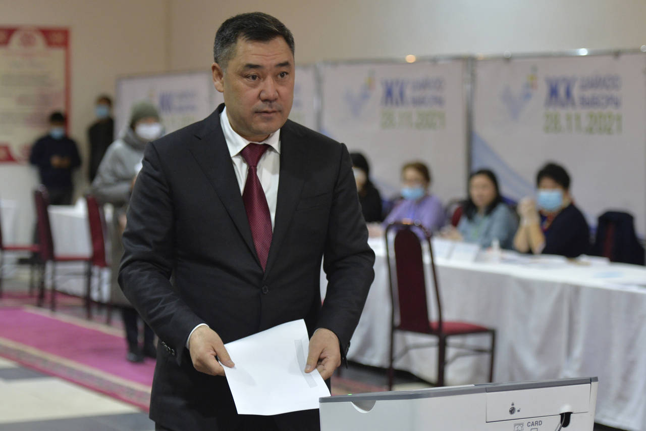 Kyrgyzstan's President Sadyr Zhaparov prepares to cast his ballot at a polling station during the p...