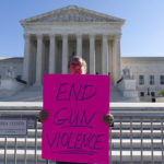 
              The Rev. Patrick Mahoney holds a sign during a rally outside of the U.S. Supreme Court in Washington, Wednesday, Nov. 3, 2021. The Supreme Court is set to hear arguments in a gun rights case that centers on New York's restrictive gun permit law and whether limits the state has placed on carrying a gun in public violate the Second Amendment. (AP Photo/Jose Luis Magana)
            